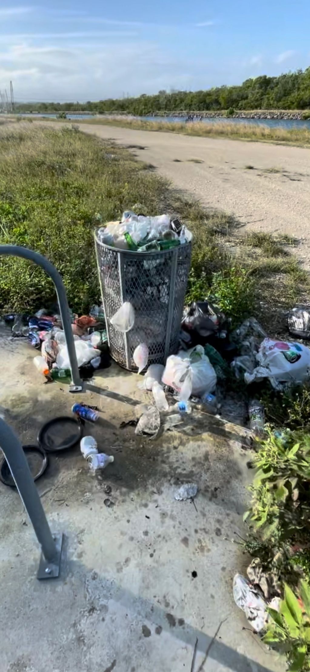 Trash overflowing from cans and scattered all over the grounds at Biscayne National Park FL 