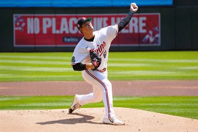 Baseball pitcher mid-throw on the mound.