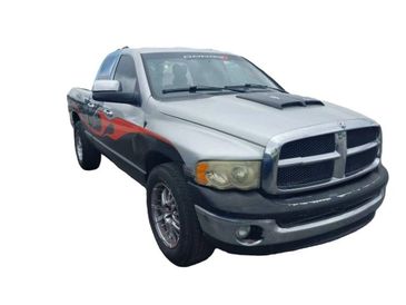 Silver and black Dodge Ram pickup truck with flame decals.