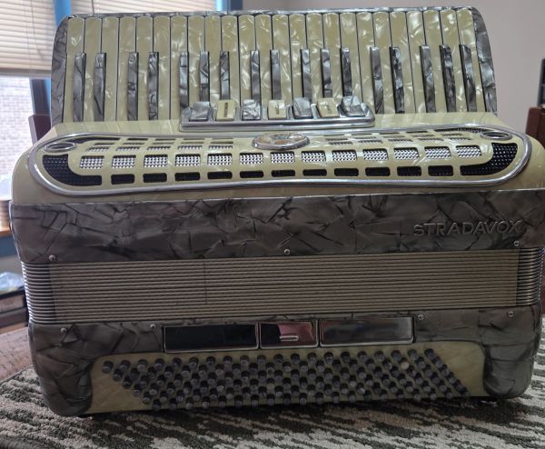 Vintage Stradavox accordion with keys and buttons.