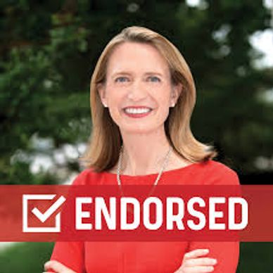 Smiling woman in red with an endorsed sign.
