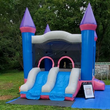 The Inflatable Icehouse Castle Combo with double slides, and indoor basketball hoop.