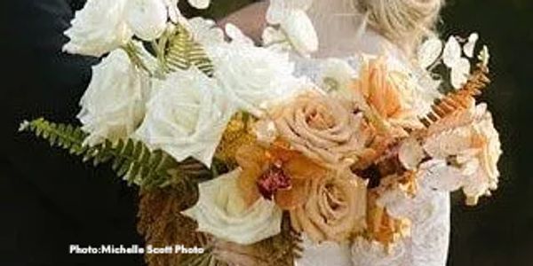 Beautiful bridal bouquet of ivory roses, Toffee roses, orchids, dried lunaria.  Bride in white and b