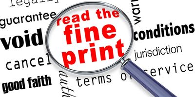 Magnifying glass highlighting the phrase 'read the fine print' among contract-related words.
