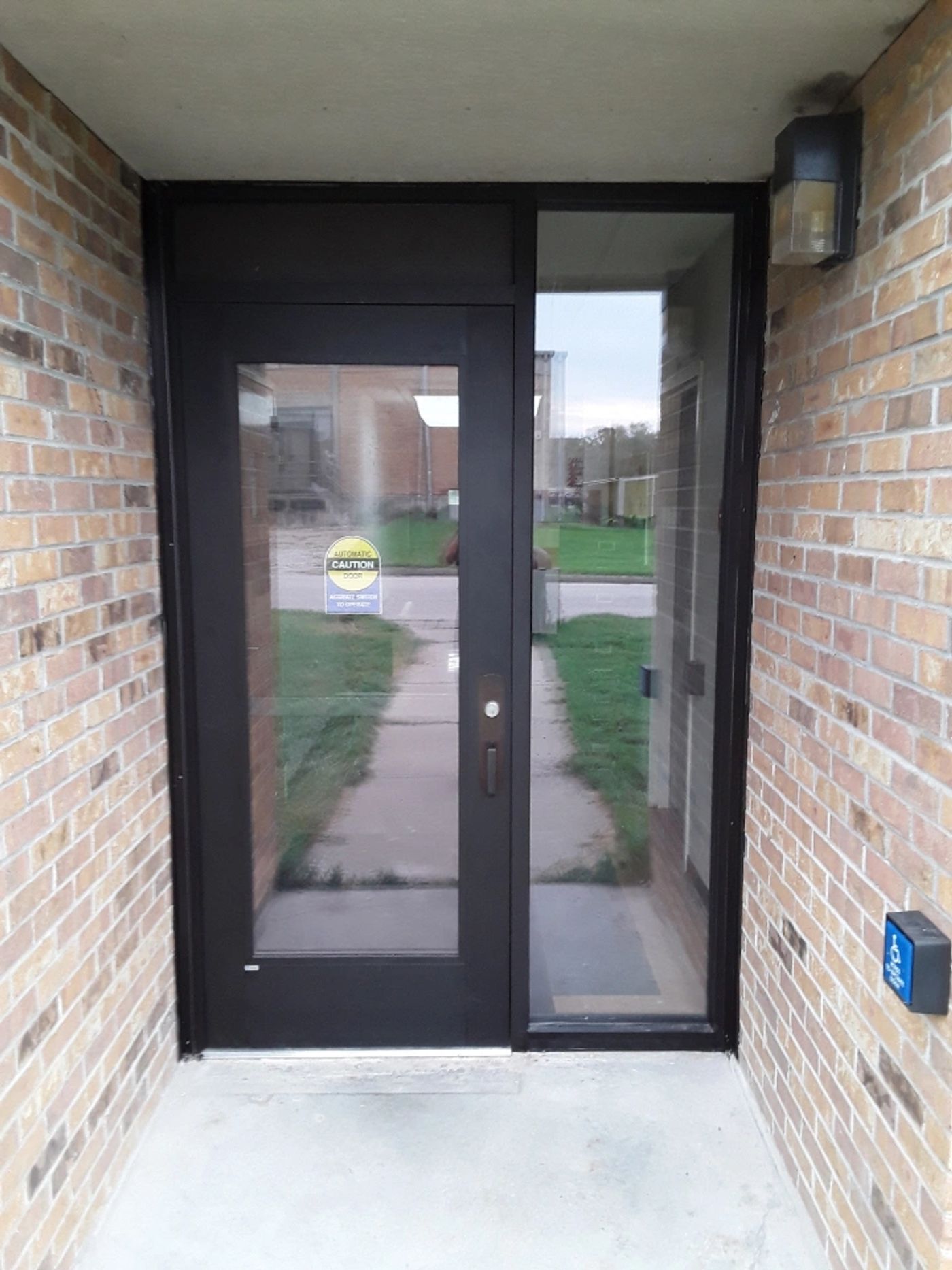 Dark aluminum storefront entry set in a brick building