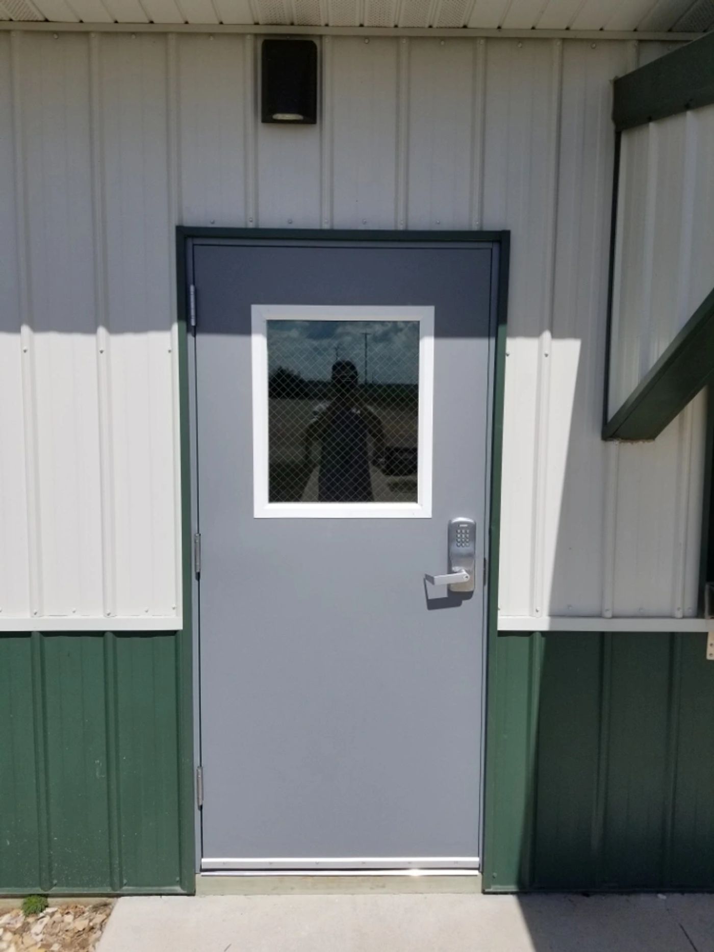 Gray steel door with a keypad access control lock