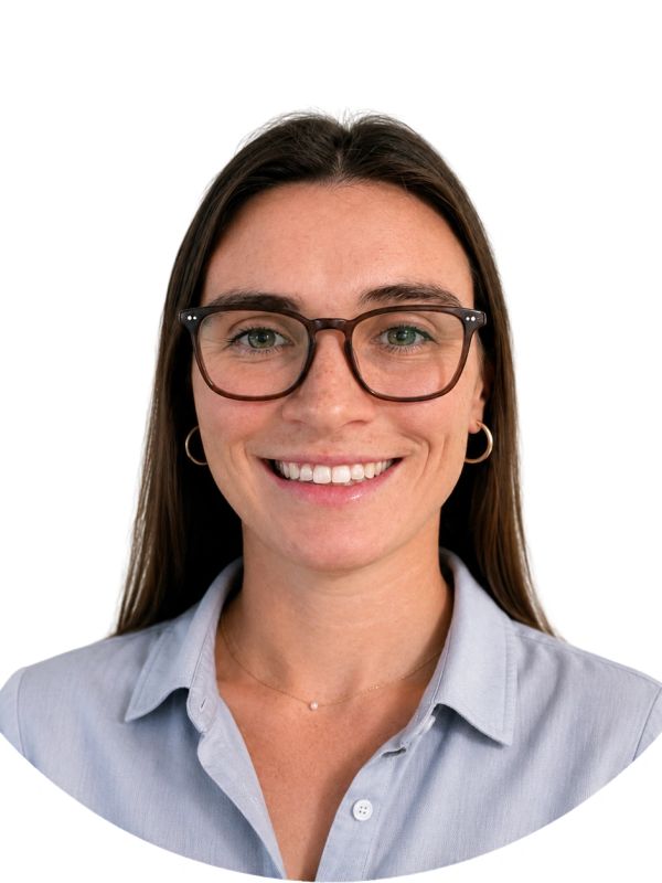 Smiling woman with glasses and long brown hair.