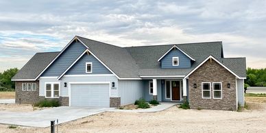 Exterior house with custom stonework painted light blue and grey