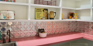 Butler's pantry with open shelving red countertop and silver metal decorative backsplash.