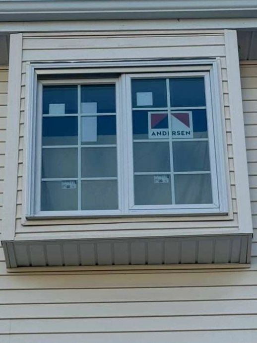 White framed window on cream siding.