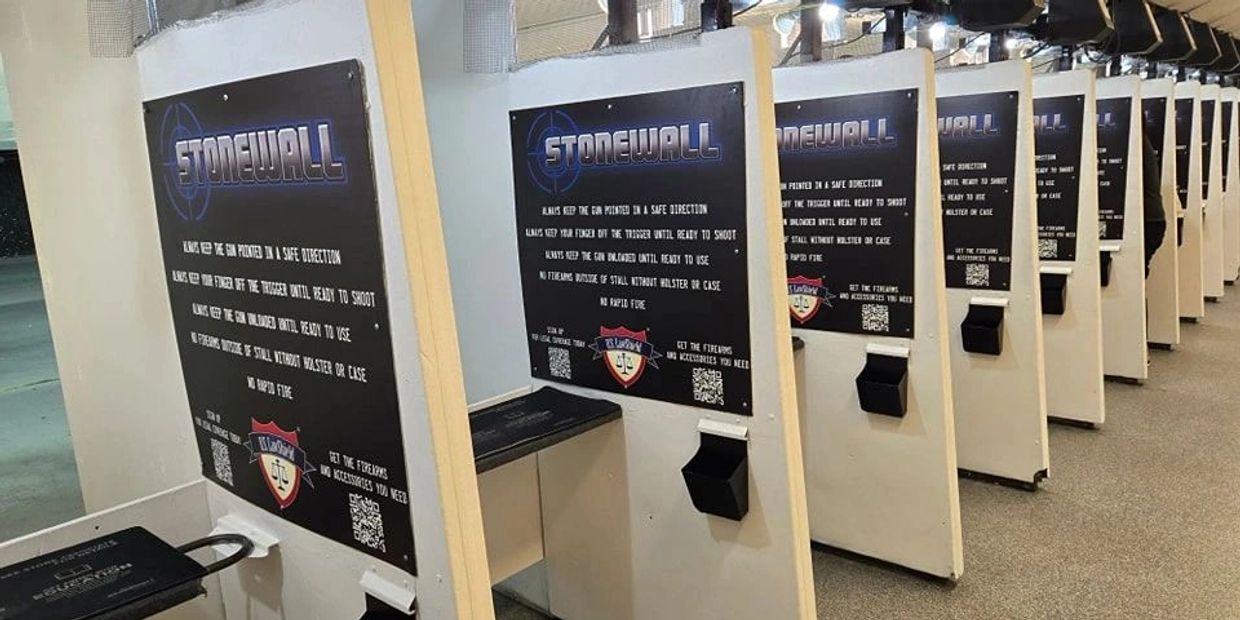 Indoor shooting range with multiple shooting booths labeled Stonewall.