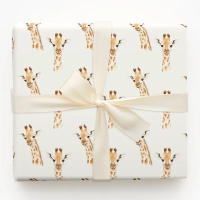 White present wrapping paper wth giraffe head illustration and white bow