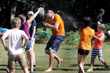 Kids having a water fight outside.