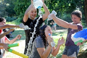 Kids enjoying a water fight outdoors.