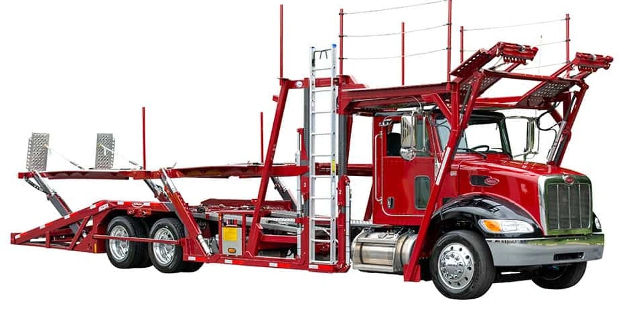 Red car carrier truck designed for transporting vehicles efficiently.