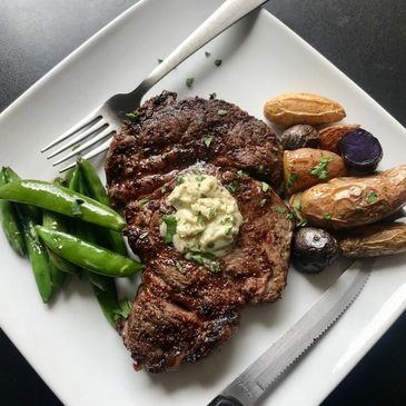 Ribeye grilled to perfection served with fresh vegetables.