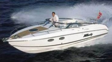A man driving a white motorboat on the water.