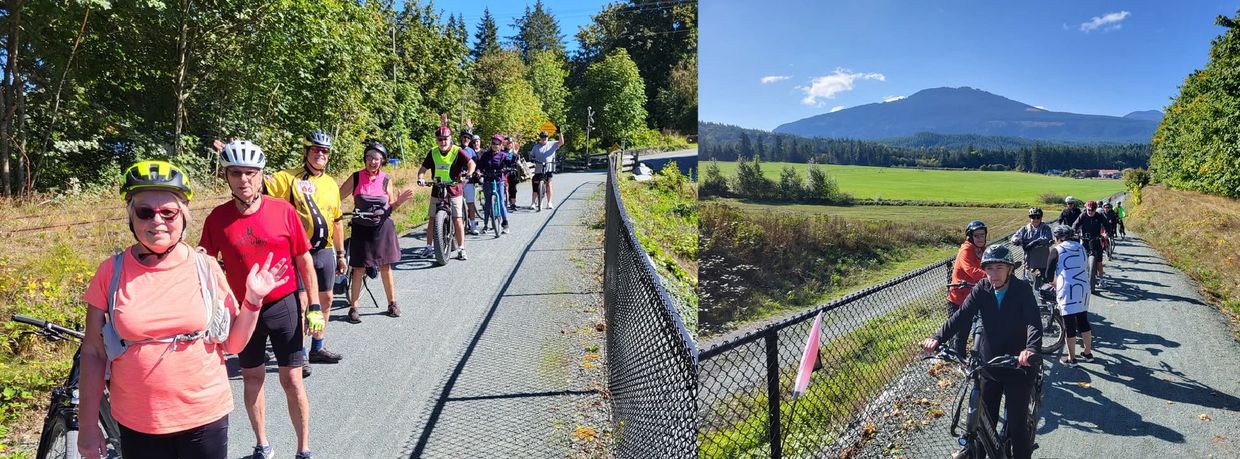 Group of cyclists posing and riding on a sunny rural trail beside the rails with mountains in the background.