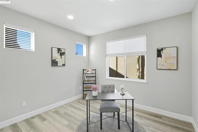 Minimalist room with modern art and windows.