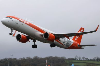 EasyJet airplane taking off against a cloudy sky.