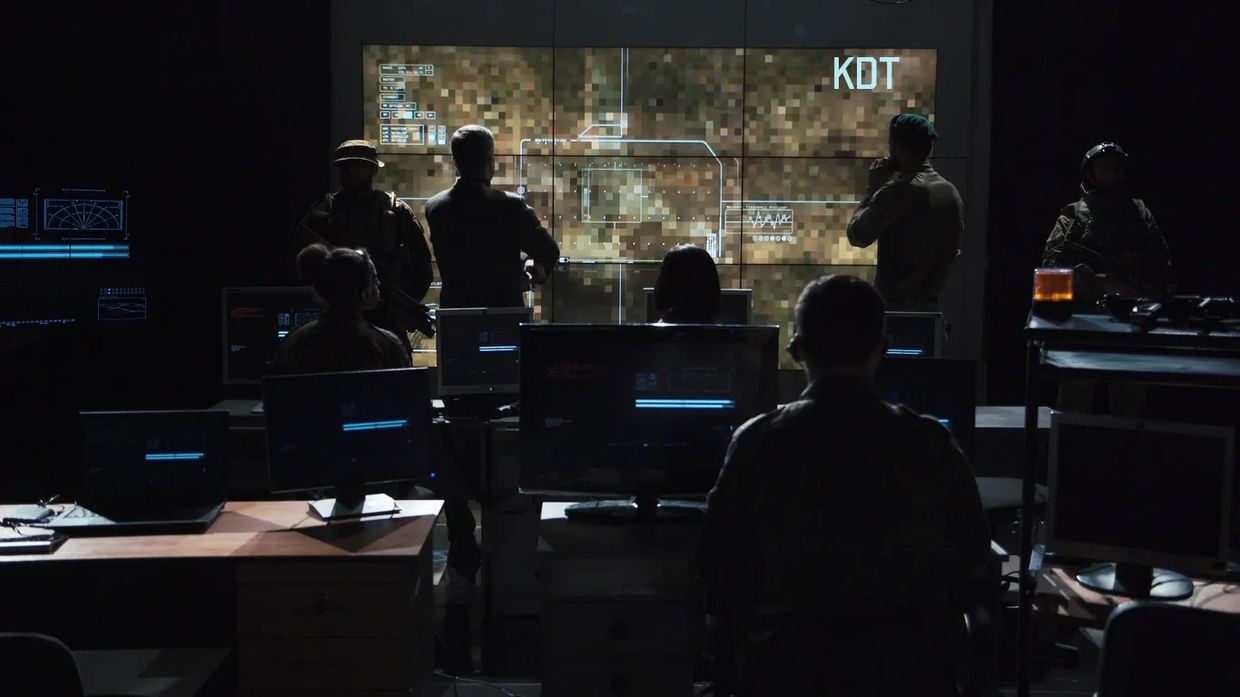 Knight Division Tactical employees having a meeting with the letters "KDT" on the topo map.