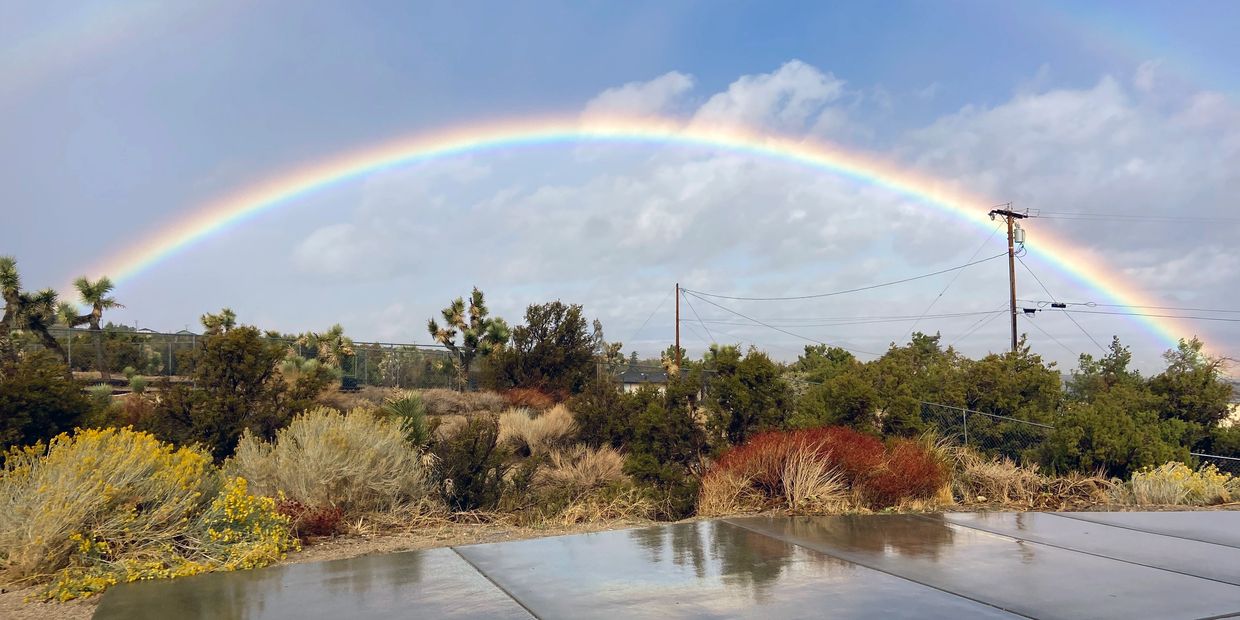 Beautiful rainbow with a faint double reflecting on the driveway at Native California Stones.