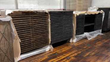 Stacked wooden and black shelves in a warehouse.