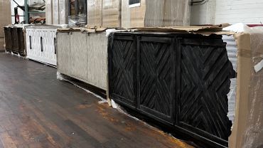 Several wooden cabinets in a warehouse setting.