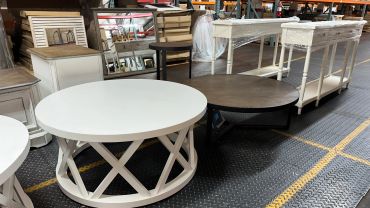 Two round coffee tables on a showroom floor.