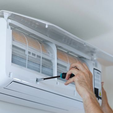 hands fixing indoor AC unit