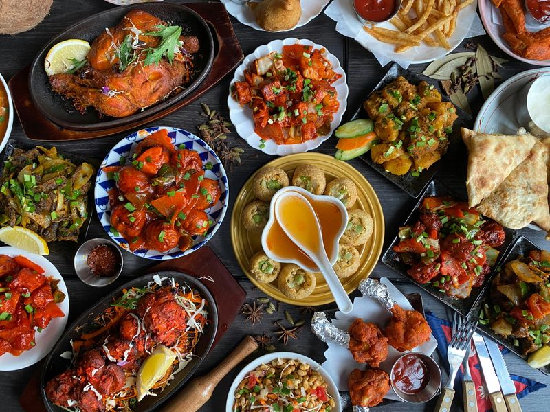 Assorted global cuisine dishes on a table featuring rich flavors and diverse foods—highlighting food tourism, cultural experiences, and international travel.