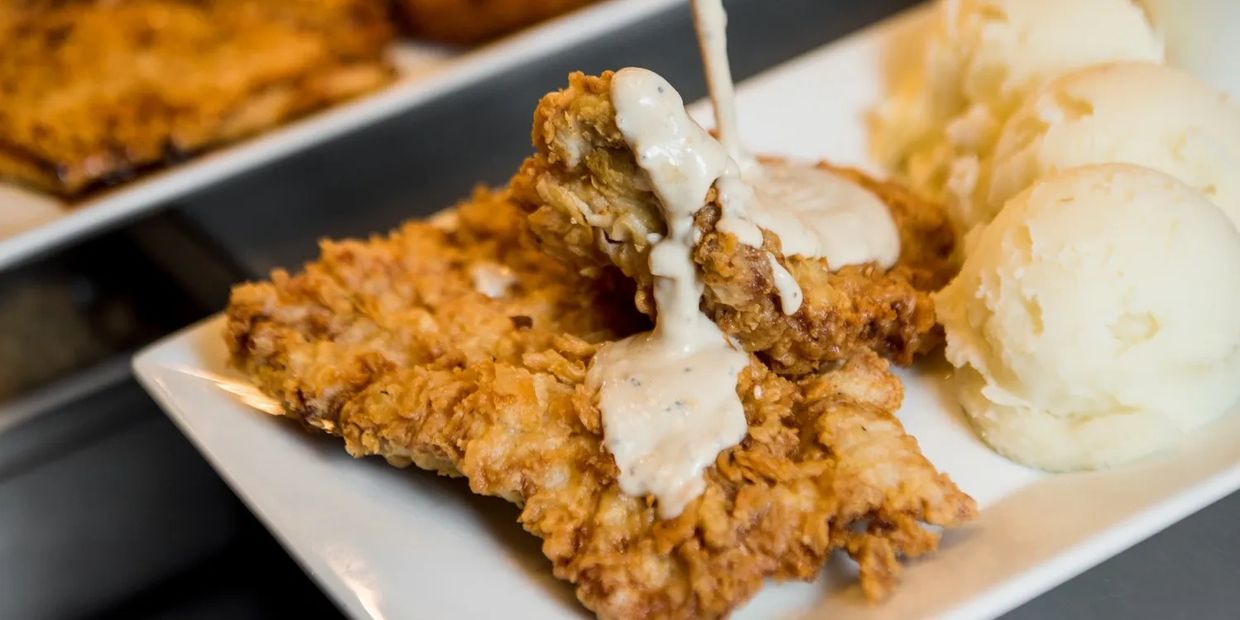 Fried Chicken With Sauce Placed in a White Color Plate