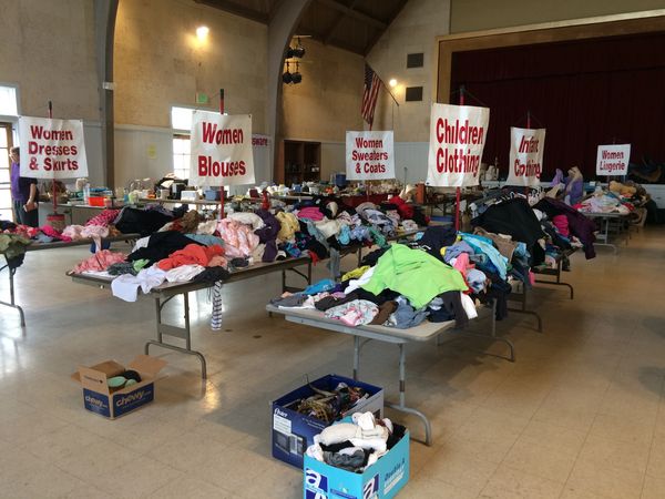 Clothing donation event with tables sorted by clothing type.