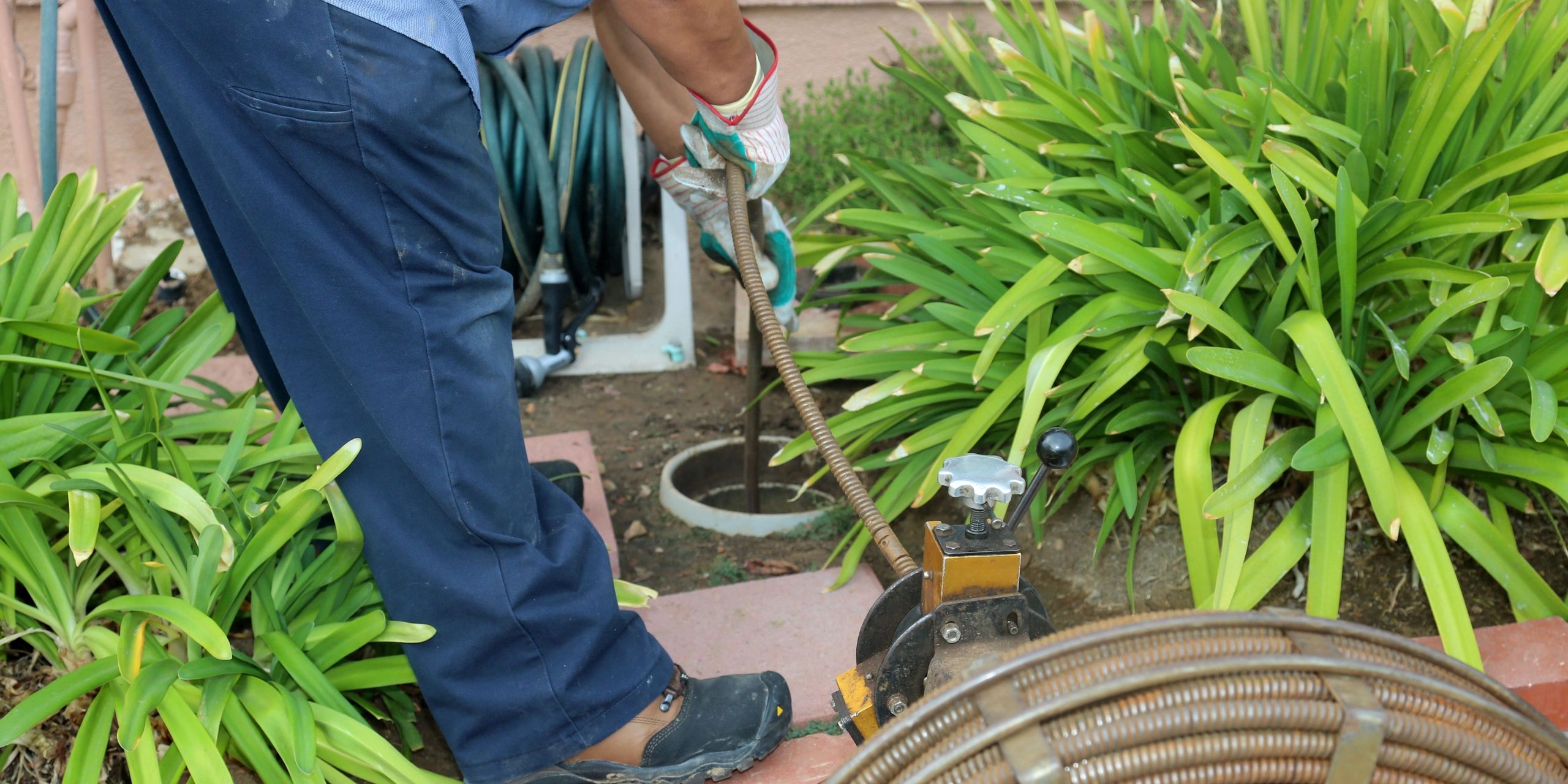 Plumber rodding sewer