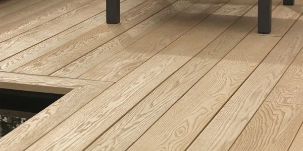 Close-up of a wooden deck with a chair leg.