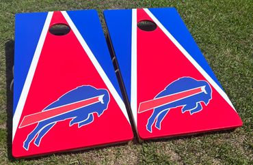 Two cornhole boards with Buffalo Bills logo on grass.