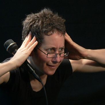 Person adjusting glasses with a microphone near.