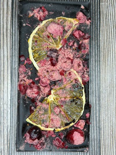 A dark chocolate bar with dried cranberry and dried orange