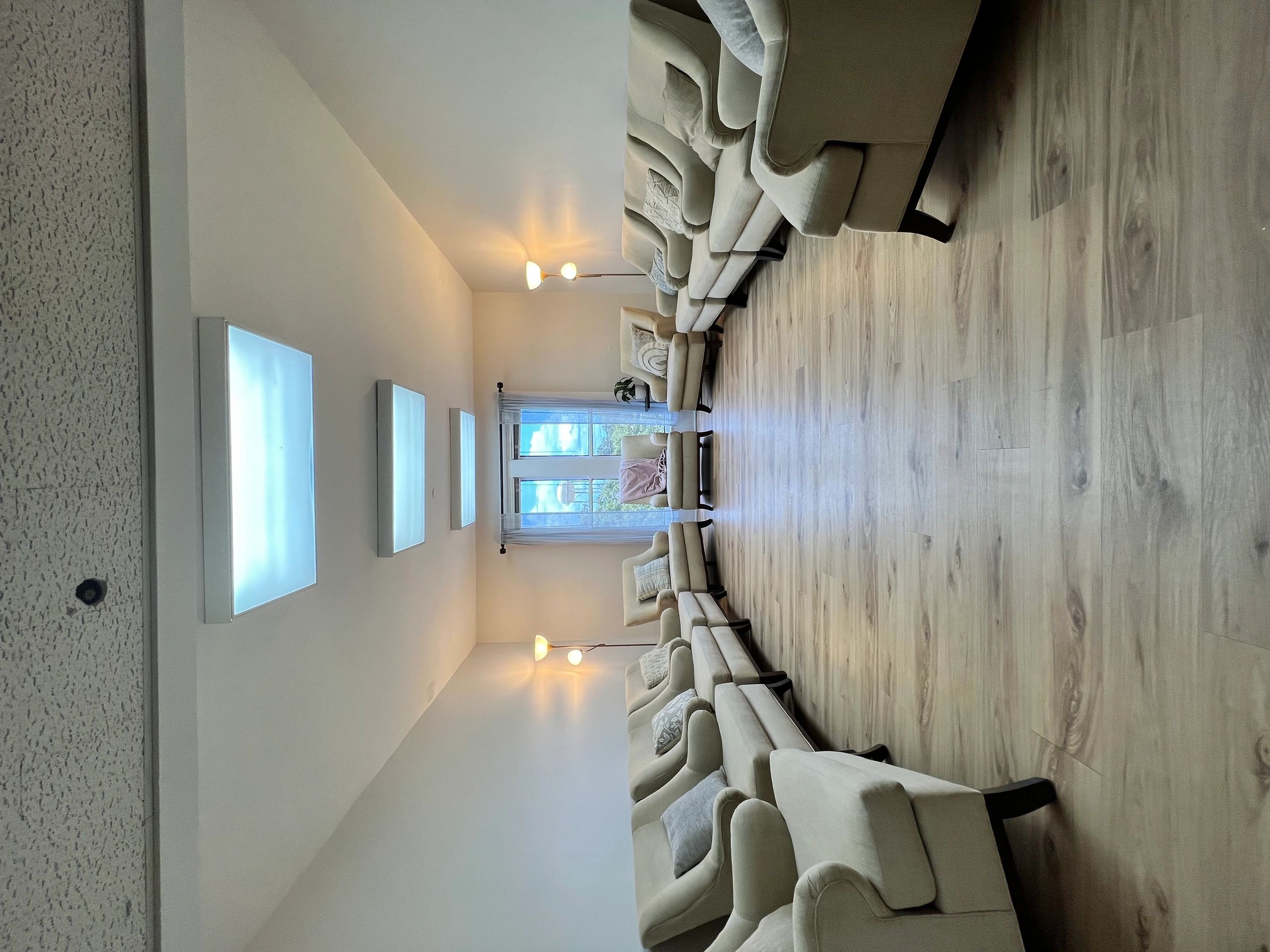 Symmetrical seating arrangement with beige armchairs in a bright room.