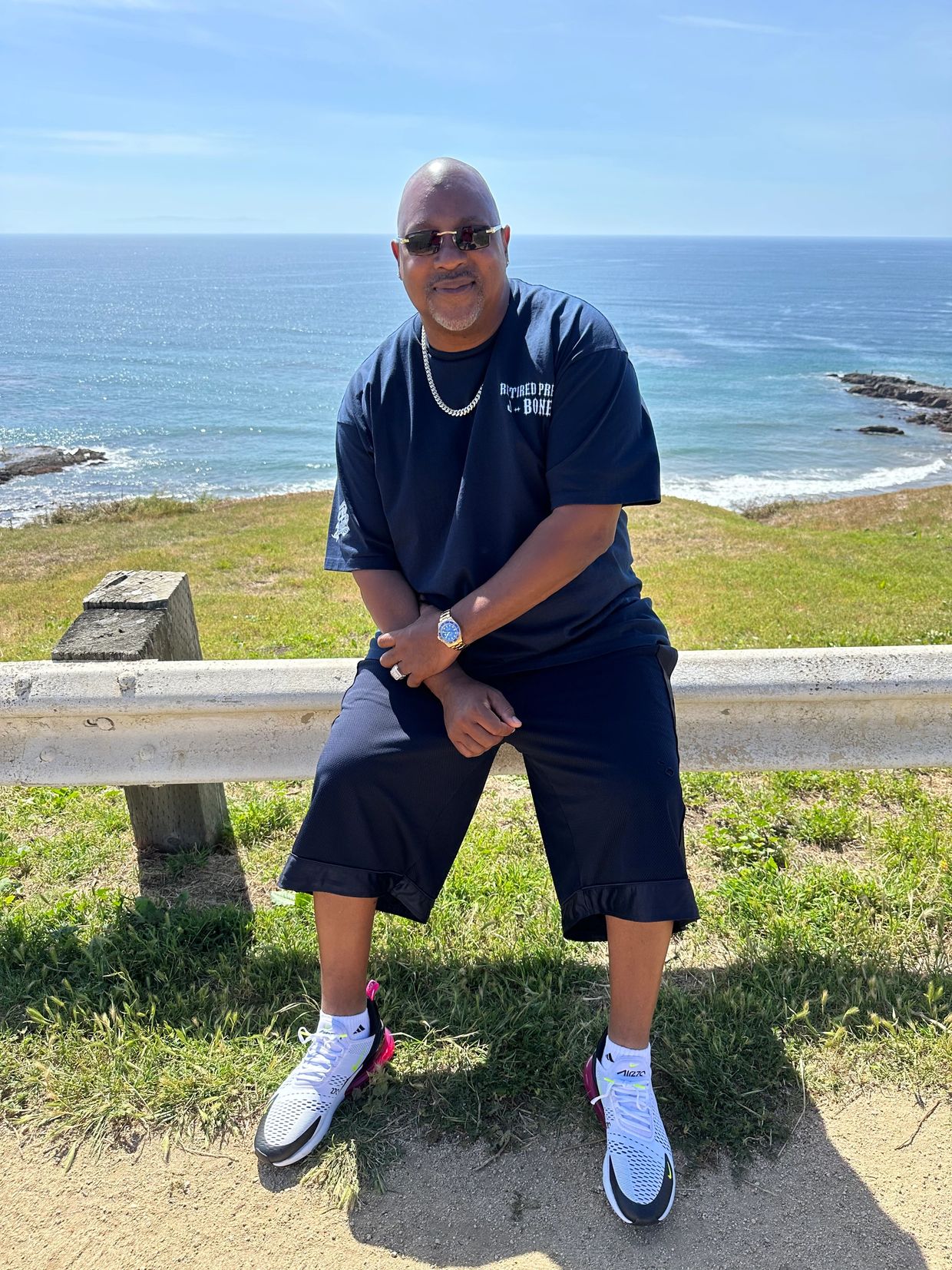 Man sitting by the seaside on a sunny day.