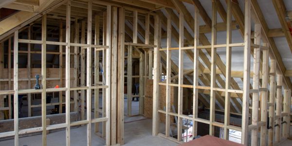 Wooden framing for walls in an attic under construction.
