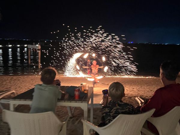 Group of people enjoying a fire show in Isla Mujeres