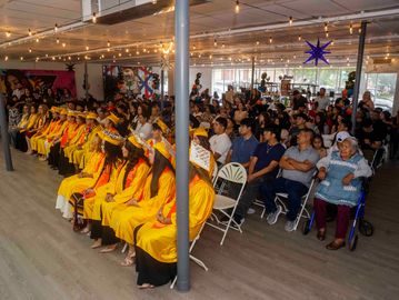 Graduation ceremony with students and audience.