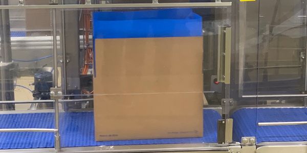 Butter foil or poly bag inserted into a box on a bulk butter packing line.