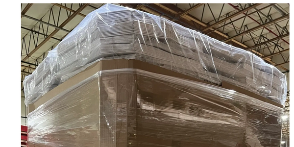 A pallet of multi-wall paper bags with a poly bag cover or shroud over the pallet. 