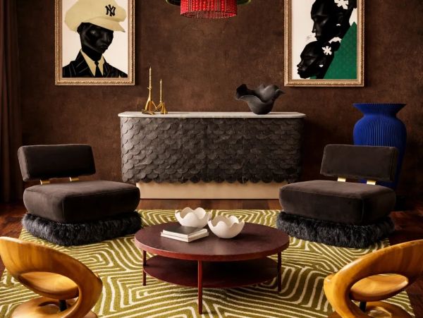 Eclectic living room with unique chairs, patterned rug, and striking wall art.