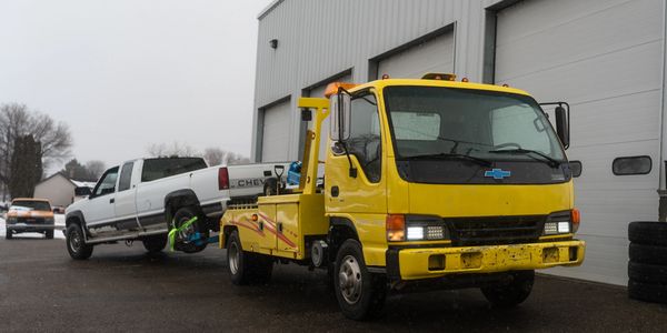 pickup truck getting towed to a automotive shop in idaho falls  