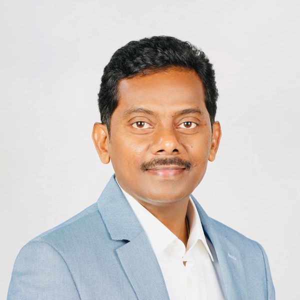 Portrait of a man in a light blue blazer.