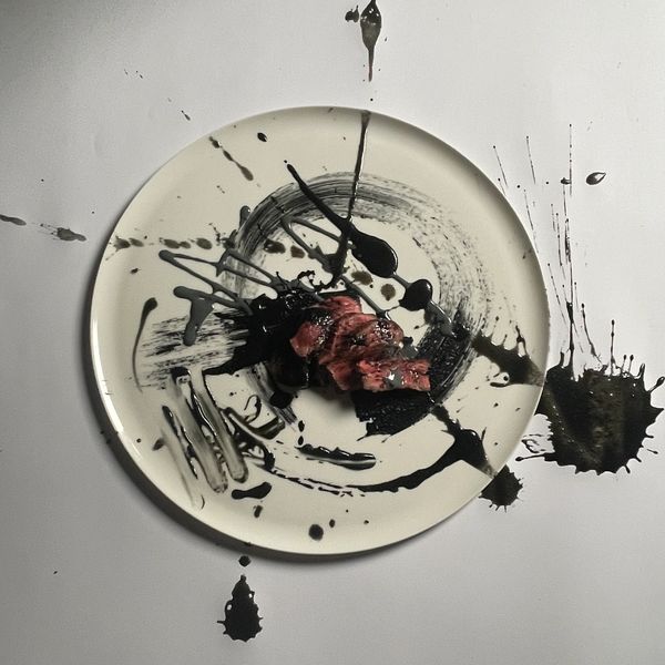 Meat dish on canvas that shows culinary art for a perfect seated dinner.