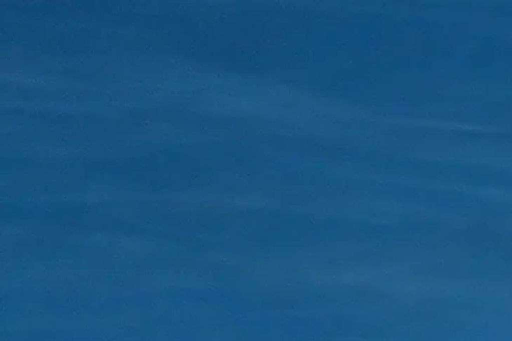 Clear blue sky with subtle wisps of clouds.